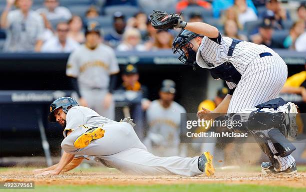 Gaby Sanchez of the Pittsburgh Pirates is tagged out by Brian McCann of the New York Yankees at Yankee Stadium on May 17, 2014 in the Bronx borough...