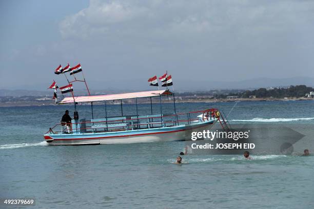 Syrians swim off the coast of Syria's Mediterranean port city of Latakia on May 19, 2014. More than 162,000 people have been killed since Syria's...