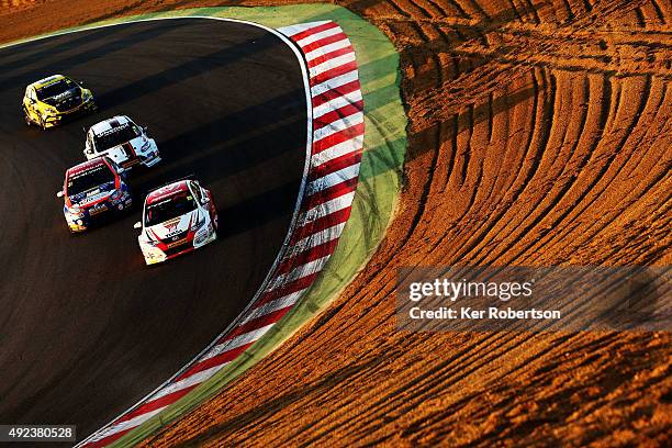 Matt Neal of Honda Racing heads a pack of cars down Paddock Hill during Race Three of the Final Round of the Dunlop MSA British Touring Car...