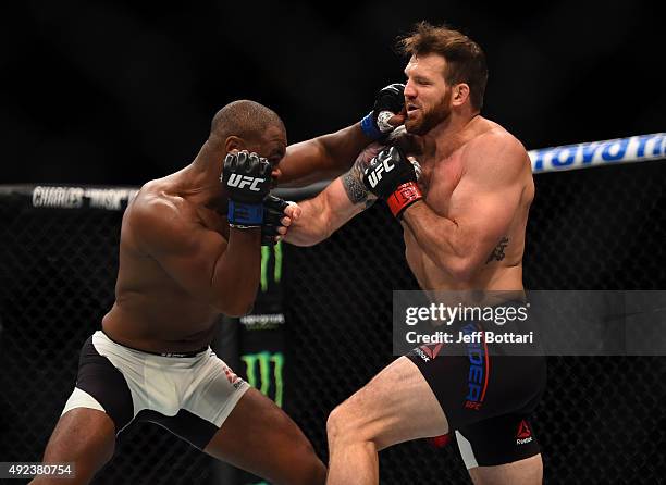 Rashad Evans punches Ryan Bader in their light heavyweight bout during the UFC 192 event at the Toyota Center on October 3, 2015 in Houston, Texas.