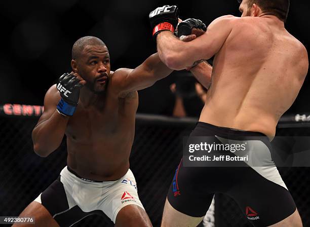 Rashad Evans punches Ryan Bader in their light heavyweight bout during the UFC 192 event at the Toyota Center on October 3, 2015 in Houston, Texas.