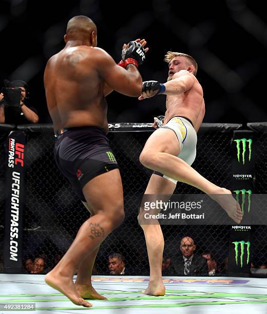 Alexander Gustafsson kicks Daniel Cormier in their UFC light heavyweight championship bout during the UFC 192 event at the Toyota Center on October...