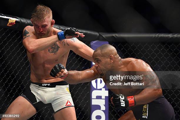 Daniel Cormier punches Alexander Gustafsson in their UFC light heavyweight championship bout during the UFC 192 event at the Toyota Center on October...