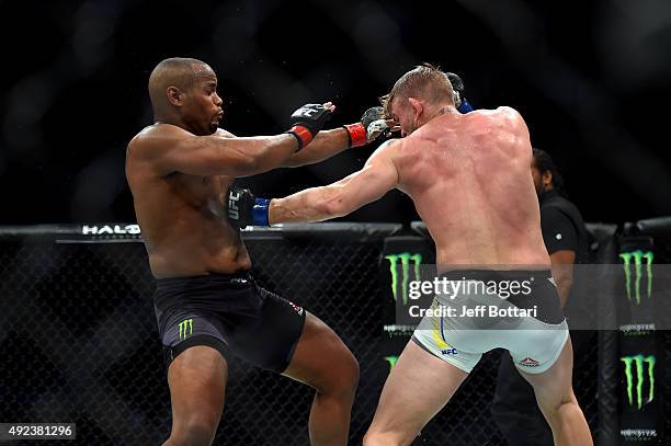 Alexander Gustafsson lands a body shot against Daniel Cormier in their UFC light heavyweight championship bout during the UFC 192 event at the Toyota...