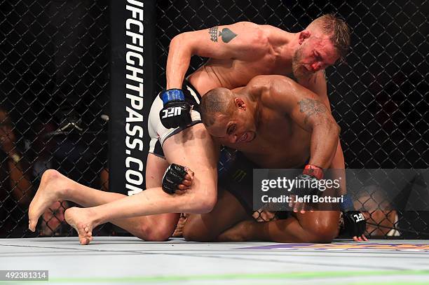 Alexander Gustafsson punches Daniel Cormier in their UFC light heavyweight championship bout during the UFC 192 event at the Toyota Center on October...