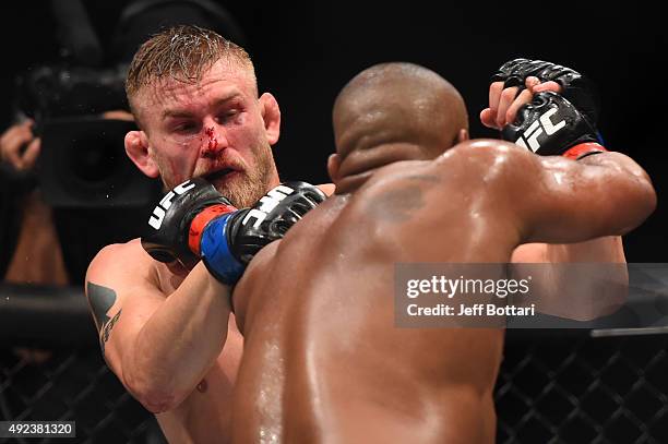 Daniel Cormier punches Alexander Gustafsson in their UFC light heavyweight championship bout during the UFC 192 event at the Toyota Center on October...