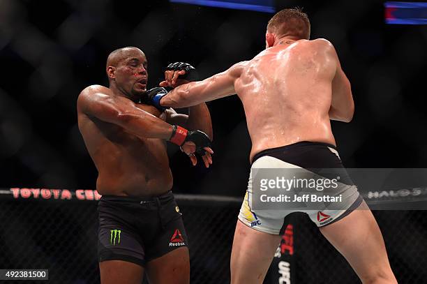 Alexander Gustafsson punches Daniel Cormier in their UFC light heavyweight championship bout during the UFC 192 event at the Toyota Center on October...
