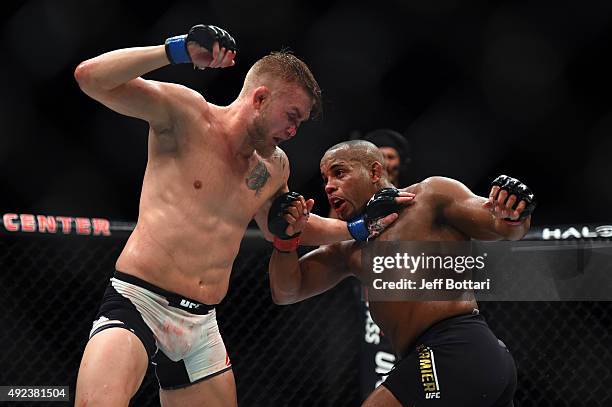 Alexander Gustafsson and Daniel Cormier exchange punches in their UFC light heavyweight championship bout during the UFC 192 event at the Toyota...