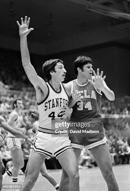 Ed Schweitzer of Stanford and Dave Meyers of UCLA play in a PAC-8 Conference college basketball game on January 17, 1975 at Maples Pavilion on the...