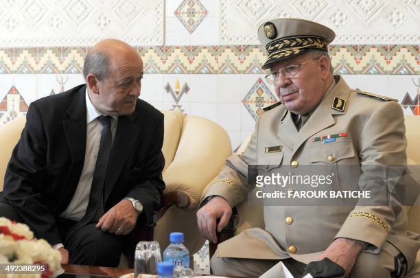French Defence Minister Jean-Yves Le Le Drian speaks with Algeria's Chief of Staff General Ahmed Gaid Salah upon his arrival at the Houari-Boumediene...