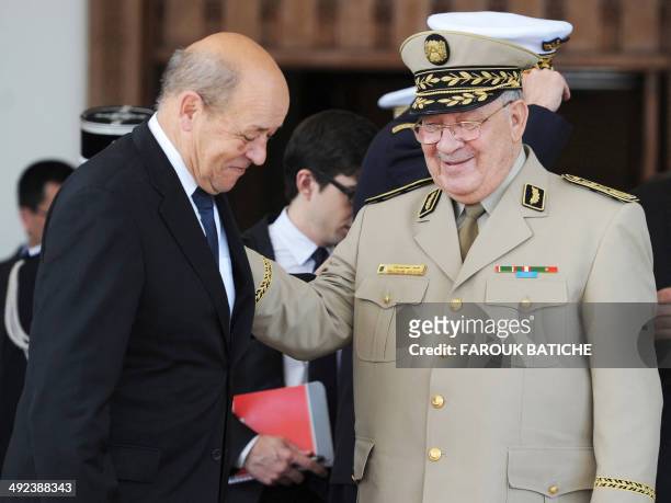 French Defence Minister Jean-Yves Le Le Drian is greeted by Algeria's Chief of Staff General Ahmed Gaid Salah upon his arrival at the...