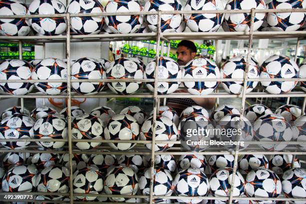 Adidas AG "Capitano Replica" soccer balls sit in a rack at the Forward Sports Ltd. Factory in Sialkot, Punjab, Pakistan, on Tuesday, Jan. 28, 2014....