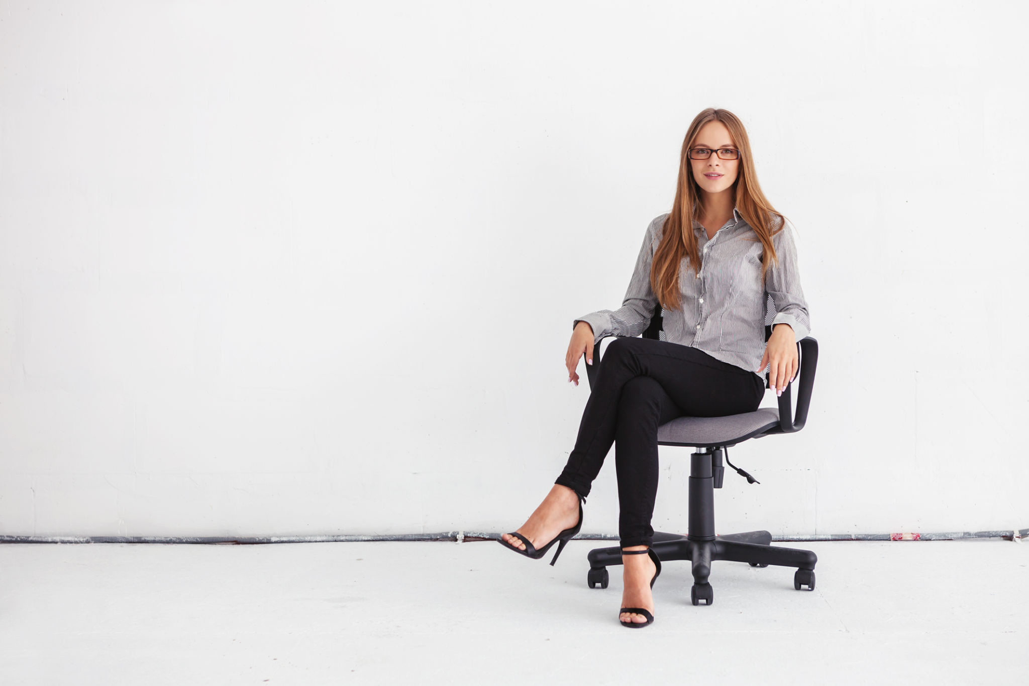 Portrait of beautiful business woman sitting on chair Portrait of beautiful business woman sitting on chair