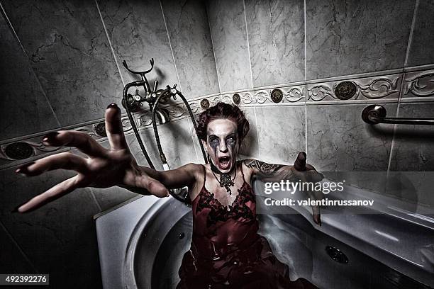 halloween theme.scary girl in bath. - young goth girls stockfoto's en -beelden