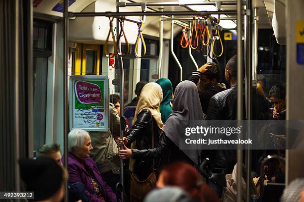 young muslim women and men in subway - senior essen stock pictures, royalty-free photos & images