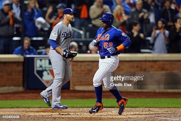 Yoenis Cespedes of the New York Mets scores off of Travis d'Arnaud single to center field in the second inning against Brett Anderson of the Los...