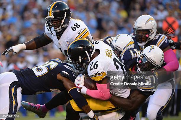 Running back Le'Veon Bell of the Pittsburgh Steelers is tackled by outside linebacker Jeremiah Attaochu of the San Diego Chargers at Qualcomm Stadium...