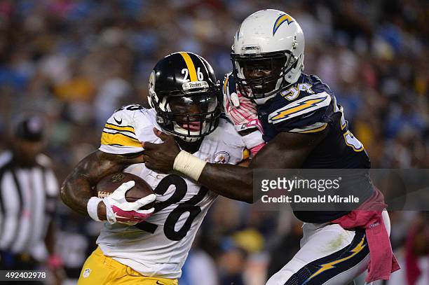 Running back Le'Veon Bell of the Pittsburgh Steelers is tackled by outside linebacker Melvin Ingram of the San Diego Chargers at Qualcomm Stadium on...