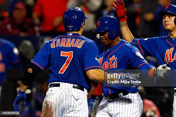 Travis d'Arnaud of the New York Mets celebrates with Yoenis Cespedes after hitting a two run home run in the third inning against Brett Anderson of...