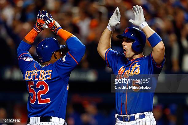 Yoenis Cespedes of the New York Mets celebrates with David Wright after hitting a three run home run against Alex Wood of the Los Angeles Dodgers in...