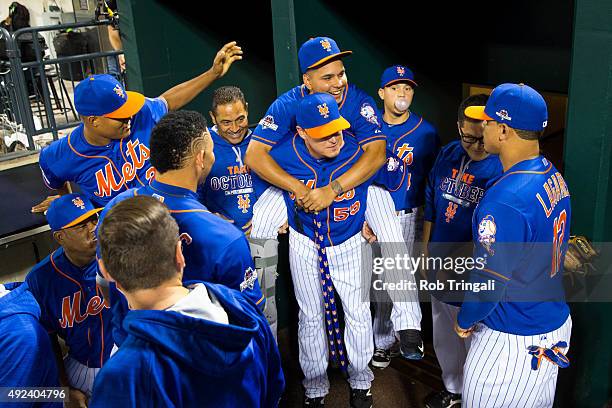 Ruben Tejada of the New York Mets receives a piggy back ride from teammate Kelly Johnson before Game 3 of the NLDS against the Los Angeles Dodgers at...