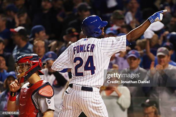 Dexter Fowler of the Chicago Cubs reacts after hitting a solo home run in the eighth inning against the St. Louis Cardinals during game three of the...