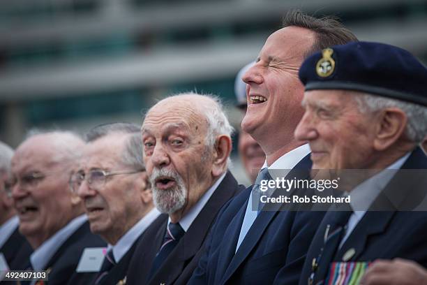 British Prime Minister David Cameron joins veterans aboard the HMS Belfast for the 70th anniversary D-Day commemorations on May 20, 2014 in London,...