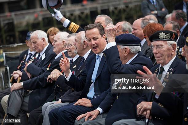 British Prime Minister David Cameron joins veterans aboard the HMS Belfast for the 70th anniversary D-Day commemorations on May 20, 2014 in London,...