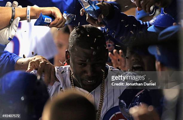Jorge Soler of the Chicago Cubs is doused with sunflower seeds in the dugout after hitting a two-run home run against the St. Louis Cardinals during...