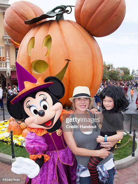 In this handout photo provided by Disney Parks, Christina Applegate and daughter Sadie LeNoble celebrate "Halloween Time" with Minnie Mouse at...
