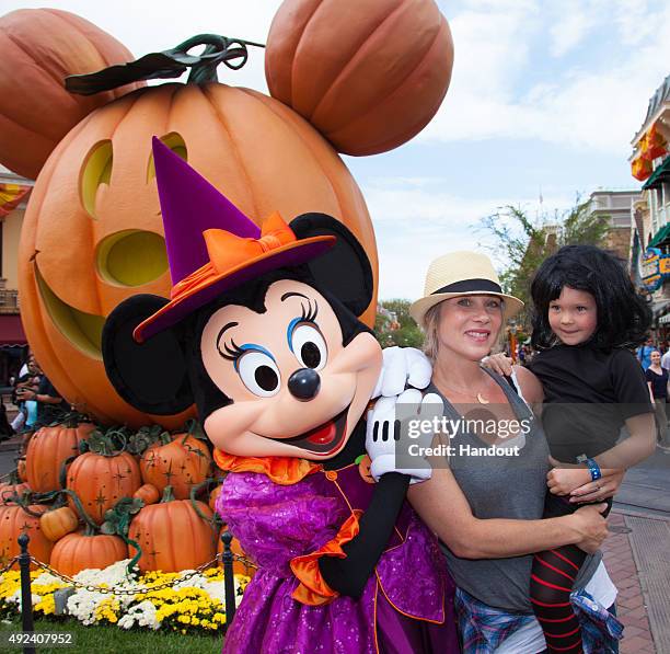 In this handout photo provided by Disney Parks, Christina Applegate and daughter Sadie LeNoble celebrate "Halloween Time" with Minnie Mouse at...