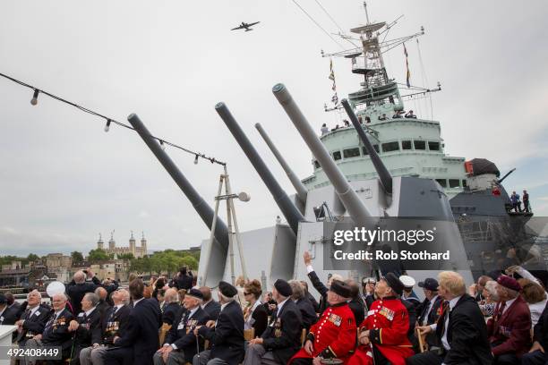 British Prime Minister David Cameron and veterans watch a C-75 Dakota fly-past along the river Thames from aboard the HMS Belfast during 70th...