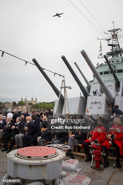 British Prime Minister David Cameron and veterans watch a C-75 Dakota fly-past along the river Thames from aboard the HMS Belfast during 70th...