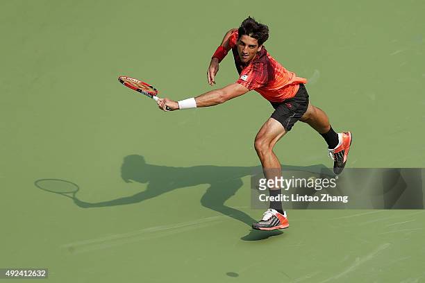 Thomaz Bellucci of Brazil returns a shot against Milos Raonic of Canada during their men's singles first round match on day 3 of Shanghai Rolex...