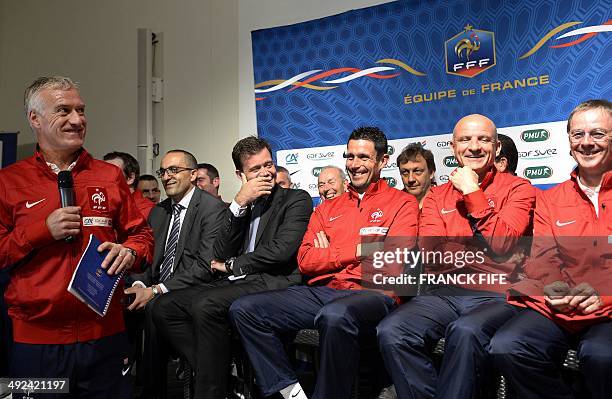 French national football team head coach Didier Deschamps smiles as he presents the team's staff security officer Mohamed Sanhadji, manager Erwan Le...