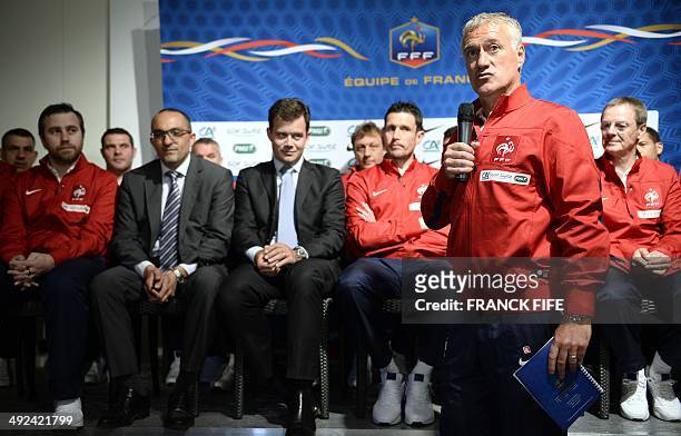 French national football team's head coach Didier Deschamps speaks as he presents the staff team administrator officer, Frederic Forestas, security...