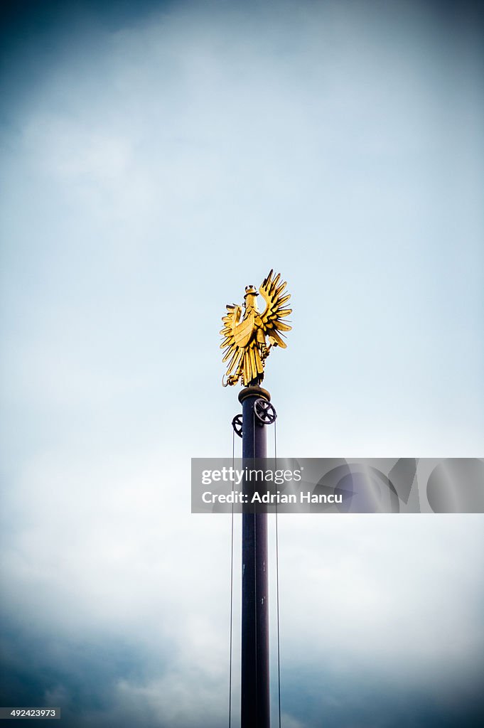 Flagpole with golden Coat of arms of Austria