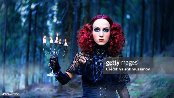 witch in the forest. halloween theme - young goth girls stockfoto's en -beelden