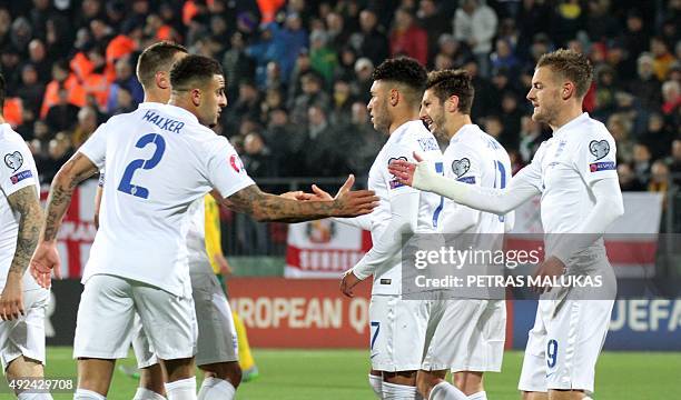 England's forward Alex Oxlade-Chamberlain celebrates with teammates scoring during the Euro 2016 Group E qualifying football match between Lithuania...