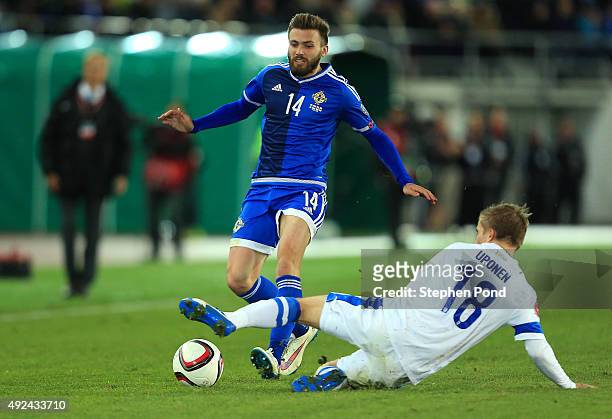Jere Oronen of Finland and Stuart Dallas of Northern Ireland compete for the ball during the UEFA EURO 2016 Qualifying match between Finland and...