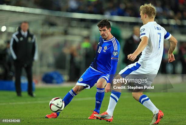 Juhani Ojala of Finland and Kyle Lafferty of Northern Ireland compete for the ball during the UEFA EURO 2016 Qualifying match between Finland and...