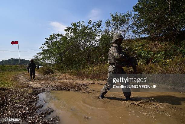South Korea soldiers patrol during a demonstration of a search operation at a training field in Cheorwon near the Demilitarized Zone dividing the two...