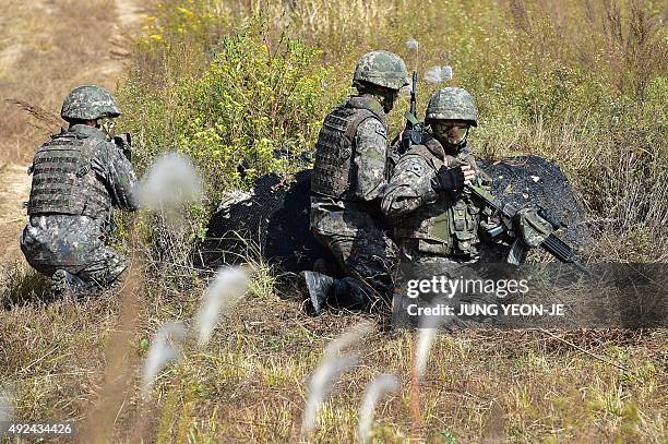 South Korea soldiers take their positions during a demonstration of a search operation at a training field in Cheorwon near the Demilitarized Zone...