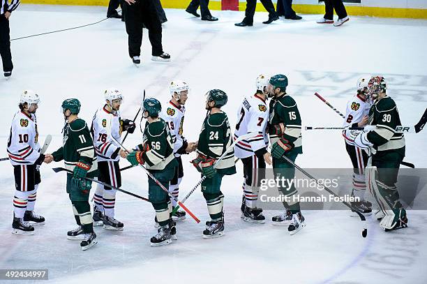 The Chicago Blackhawks and Minnesota Wild shake hands after the Blackhawks won Game Six of the Second Round of the 2014 NHL Stanley Cup Playoffs on...