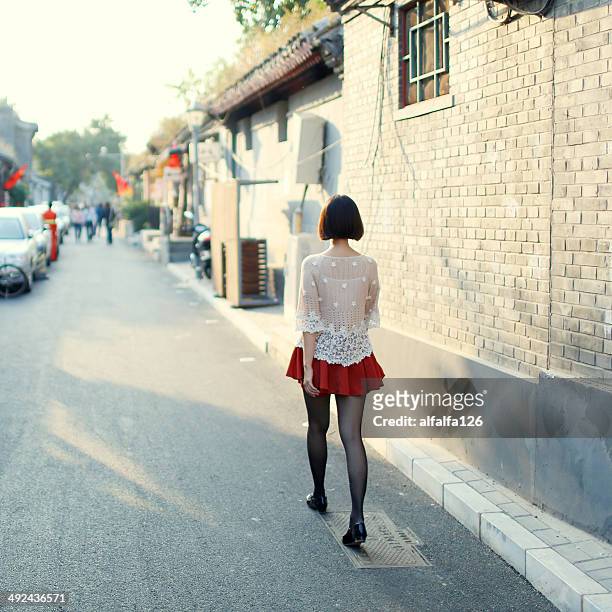 sunset time at hutong - short skirts in cars stock-fotos und bilder