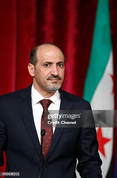 President of the Syrian National Coalition, Ahmad Jarba, attends a press conference with French President Francois Hollande after a meeting on May...