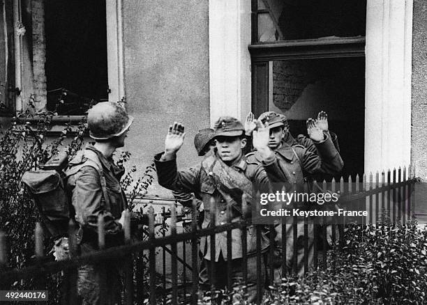 German soldiers surrendering to US forces during the search in the rubbles of the city on April 2, 1945 in Mannheim, Germany.
