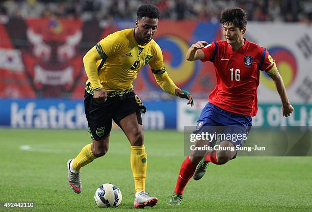 Giles Barnes of Jamaica competes for the ball with Ki Sung-Yeung of South Korea during the international friendly match between South Korea and...