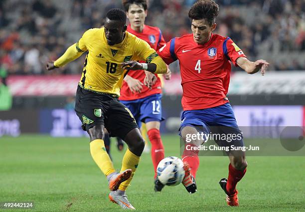 Simon Dawkins of Jamaica competes for the ball with Kim Kee-Hee of South Korea during the international friendly match between South Korea and...