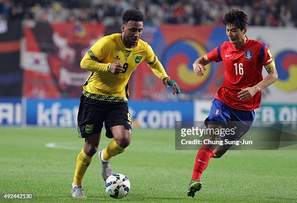 Giles Barnes of Jamaica competes for the ball with Ki Sung-Yeung of South Korea during the international friendly match between South Korea and...